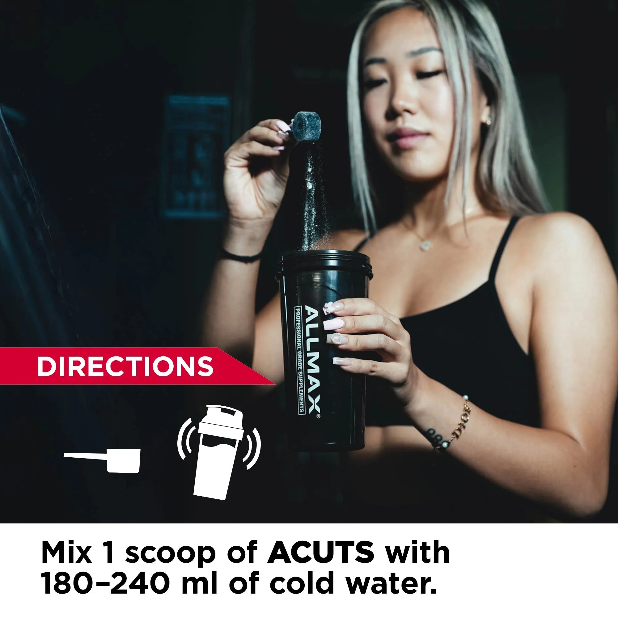 Woman holding a supplement container with Allmax branding, dark background