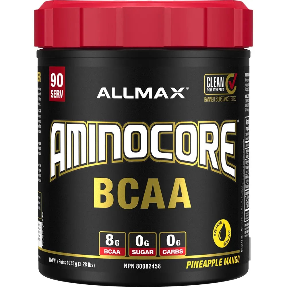 A tub of Allmax Aminocore BCAA dietary supplement in Pineapple Mango flavor, featuring a black container with a red lid and white and gold lettering.