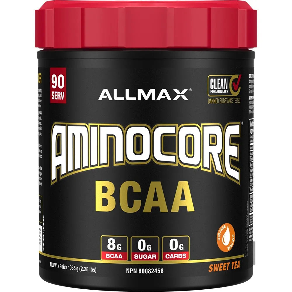 A tub of Allmax Aminocore BCAA supplement powder in Sweet Tea flavor. The container has a black label with a bright red lid, featuring white and gold text, and nutritional badges indicating 8g BCAA, 0g sugar, and 0g carbs.