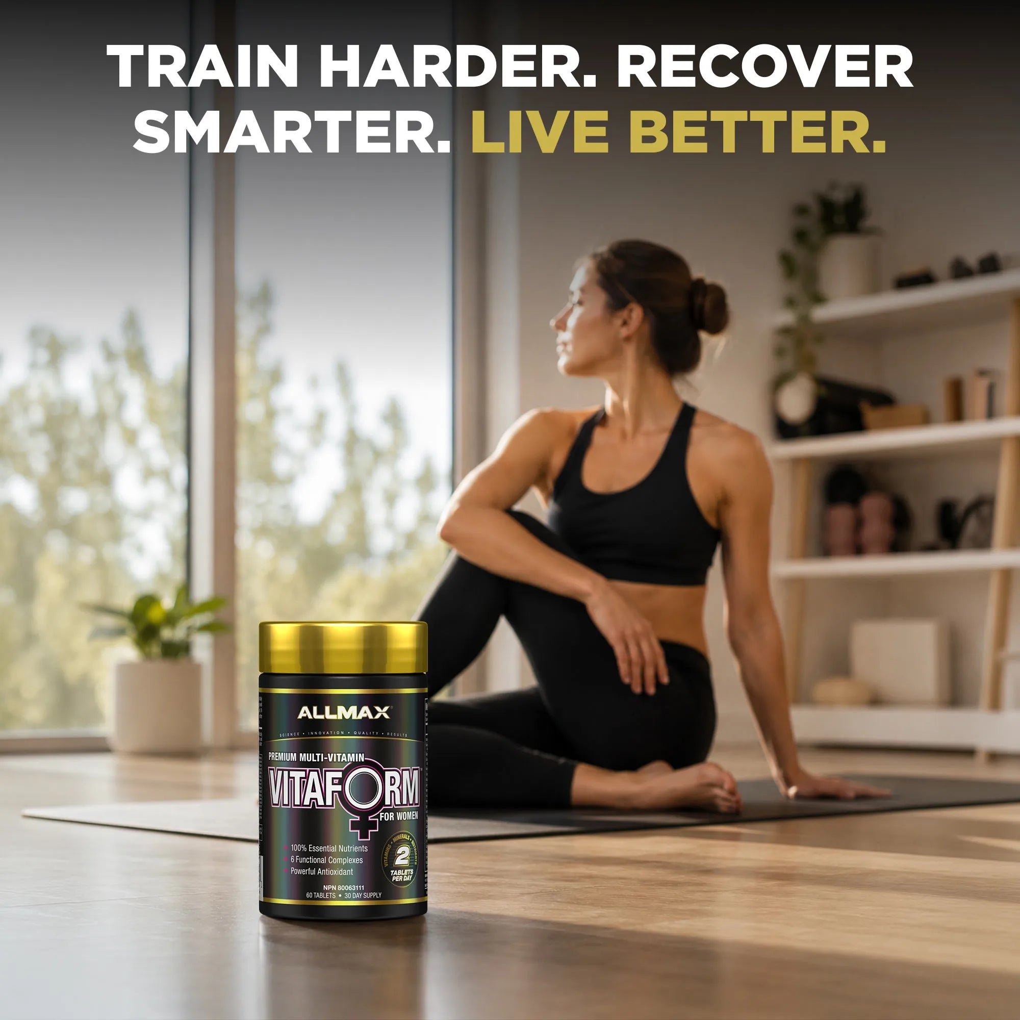 A woman in a black sports bra and leggings sits on a yoga mat in a bright home gym, with a bottle of ALLMAX VitaForm Plus Nutrition supplement in the foreground. Large text at the top reads: 'TRAIN HARDER.